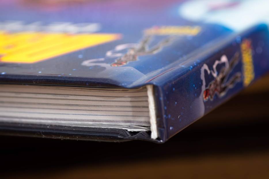 Hardcover books have a thick cover that is made from a board paper and wrapped with a custom printed graphic or book binding cover material like linen or leather