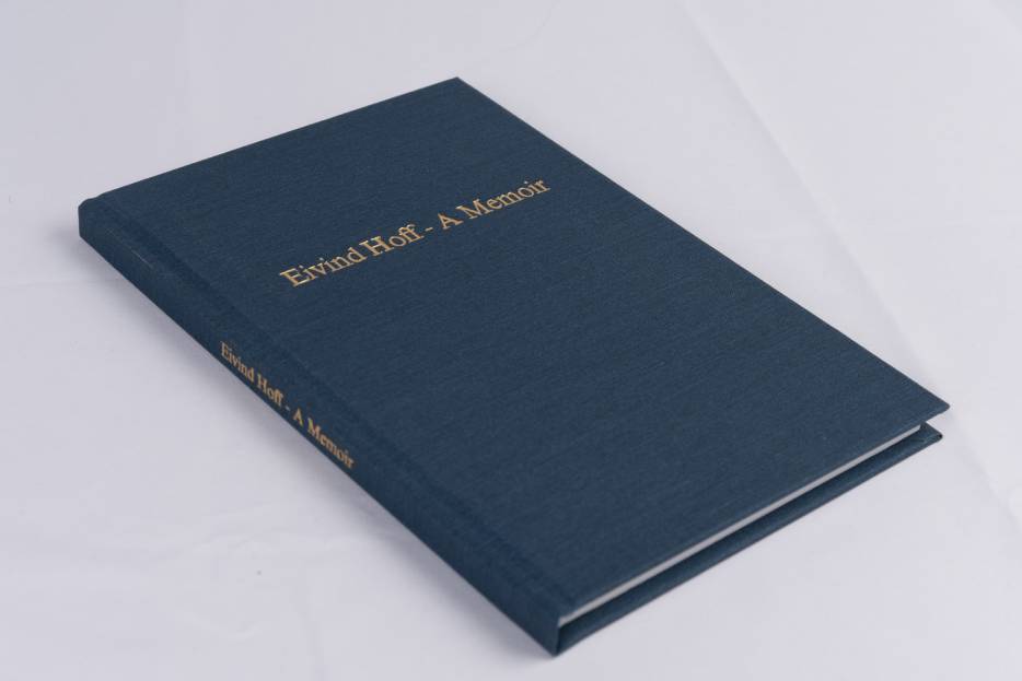 This is a hardcover book with a navy coloured linen wrapped around the cover and foil stamped in gold